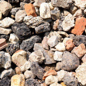 Close-up of 20/40 recycled aggregate in Runfold, Surrey: uneven lumps of concrete, brick, and stone in various sizes and colours.