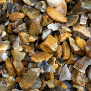 Wet, multicoloured 4–10mm gravel pebbles from Runfold, Surrey in brown, tan, grey, and white with a glossy look.