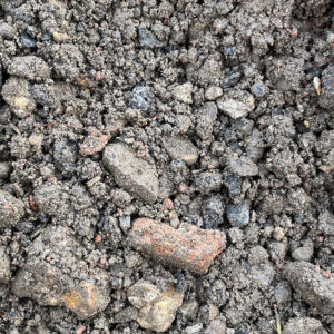 Close-up of Type 1 Reblend 50/50 SHW Clause 803 in Runfold, showing coarse soil with varied stones in brown, grey, and orange.